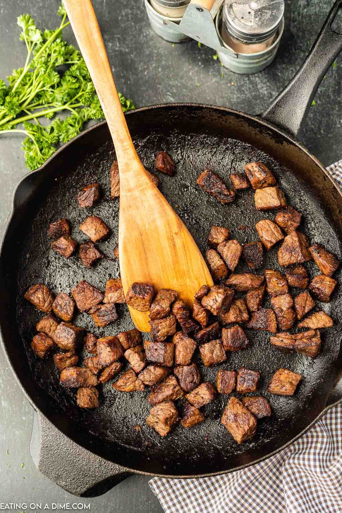 Garlic butter steak bites in a pan. 