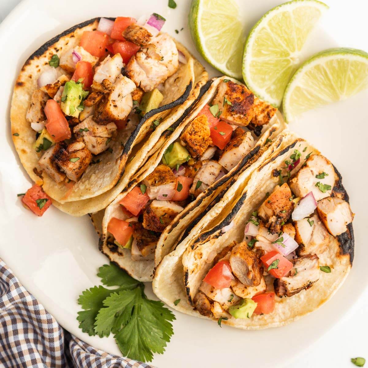 Grilled chicken tacos on a plate. 