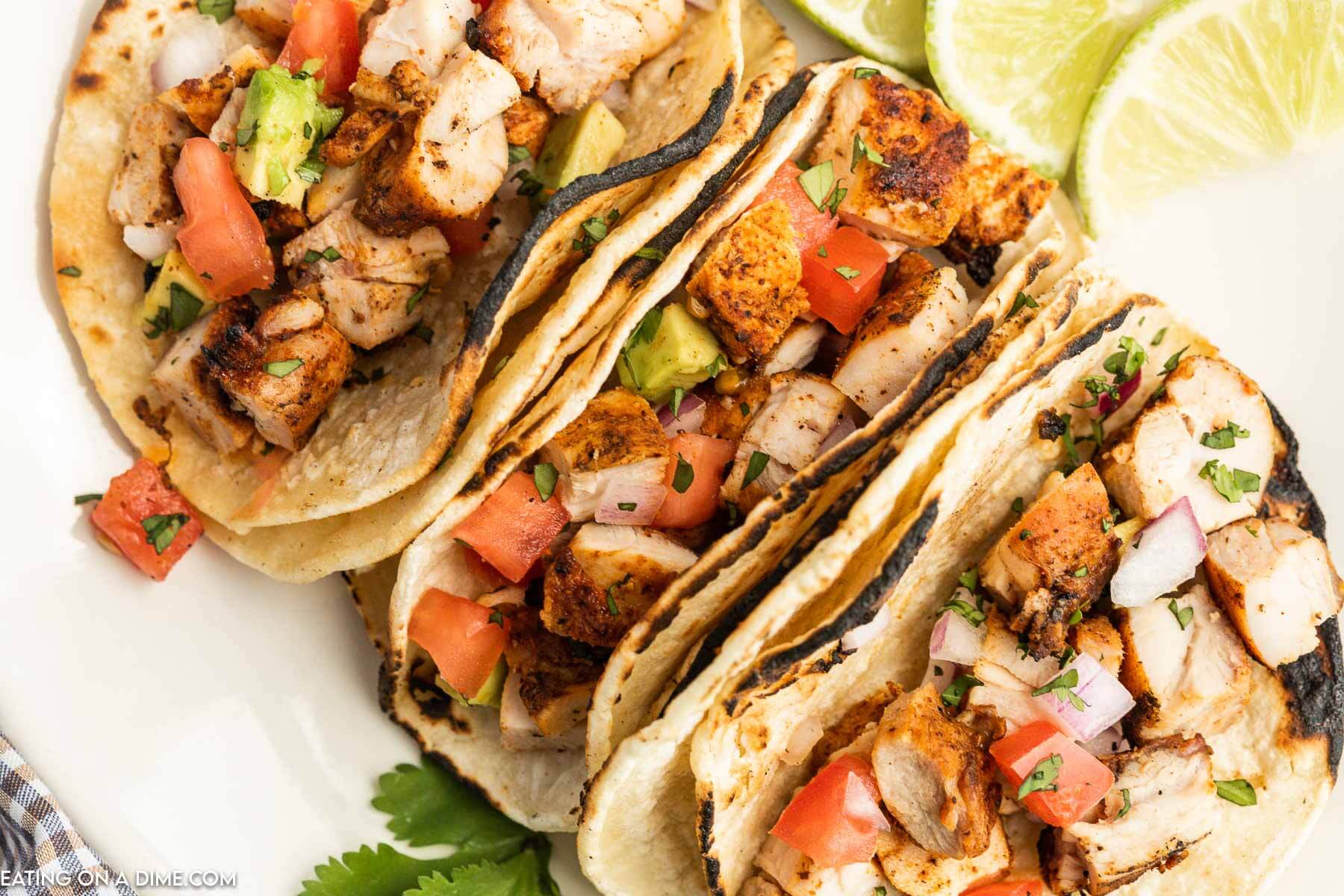 Grilled chicken tacos on a plate. 