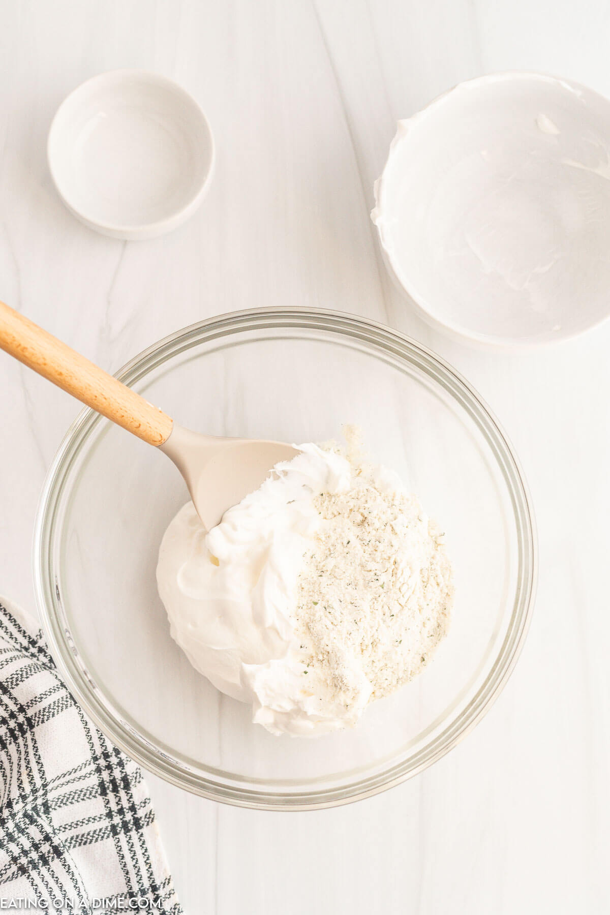 Mixing the sour cream with dressing mix