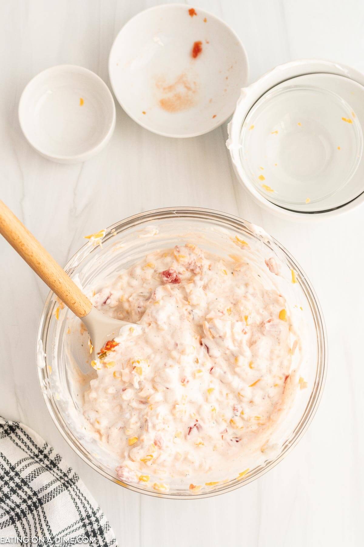 Mixing the ingredients in a clear bowl with a wooden spoon