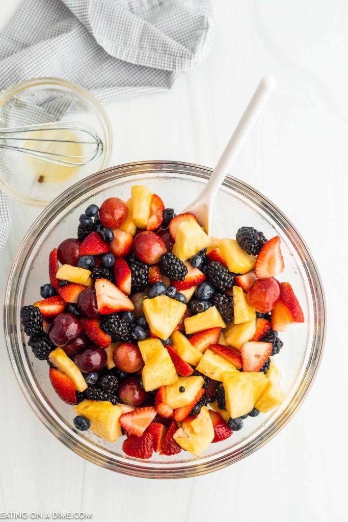 Combining the fruit salad with the dressing