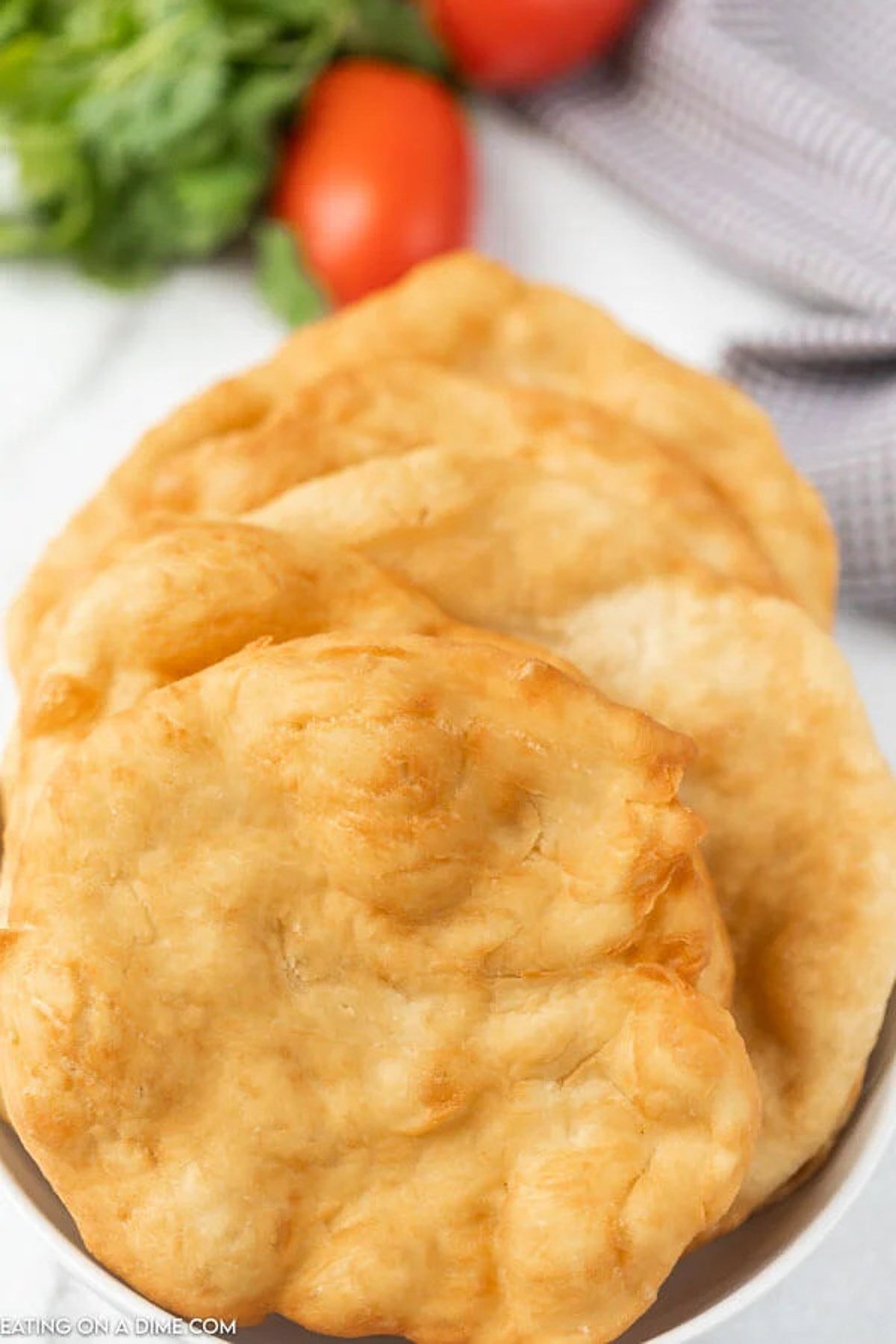 Indian fry bread stacked on a plate. 