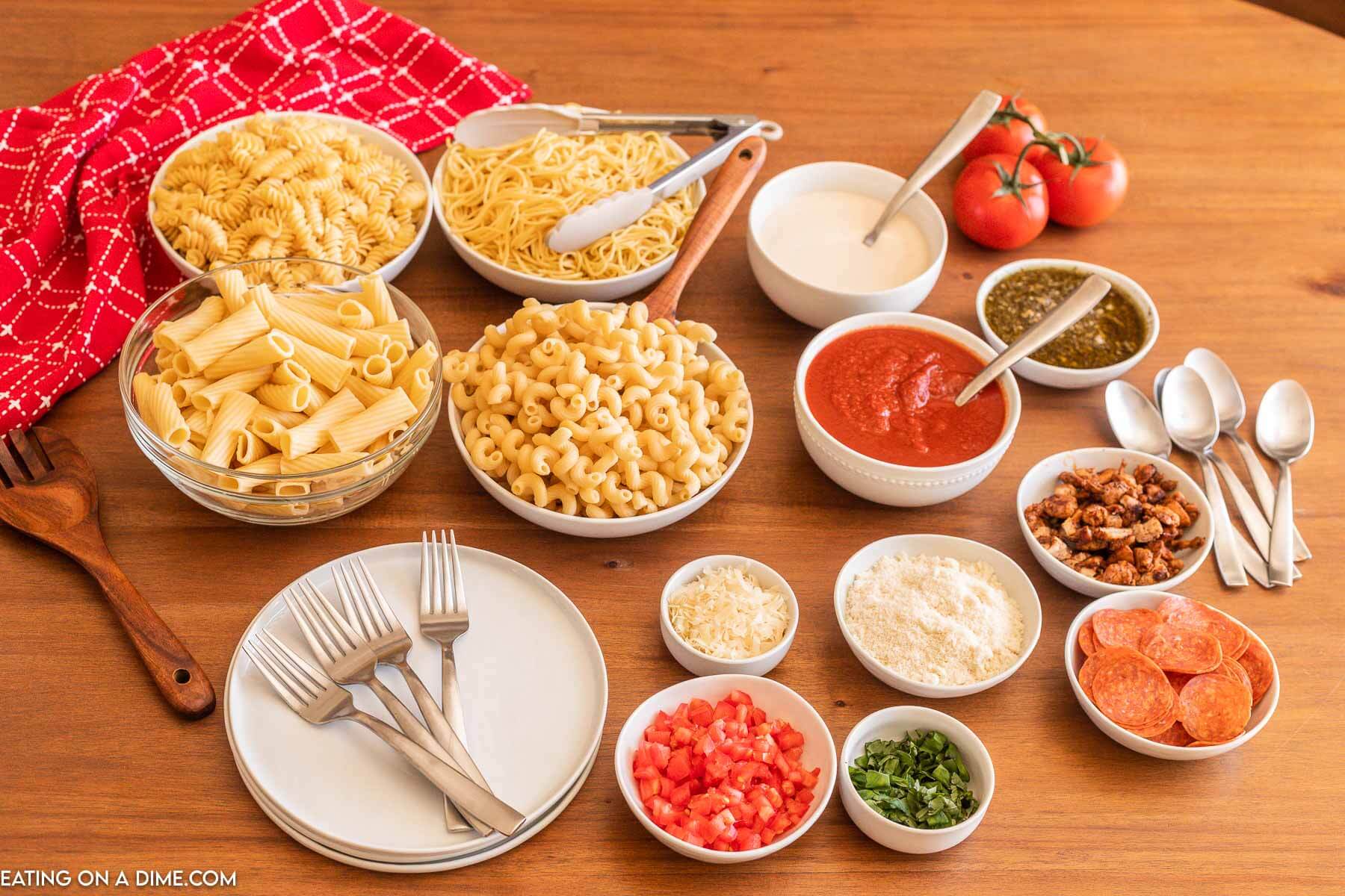 Bowls of pasta, sauces and toppings for a pasta bar