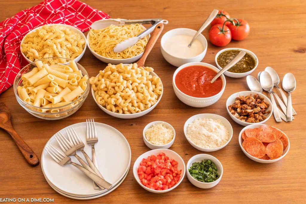Bowls of pasta, sauces and toppings for a pasta bar