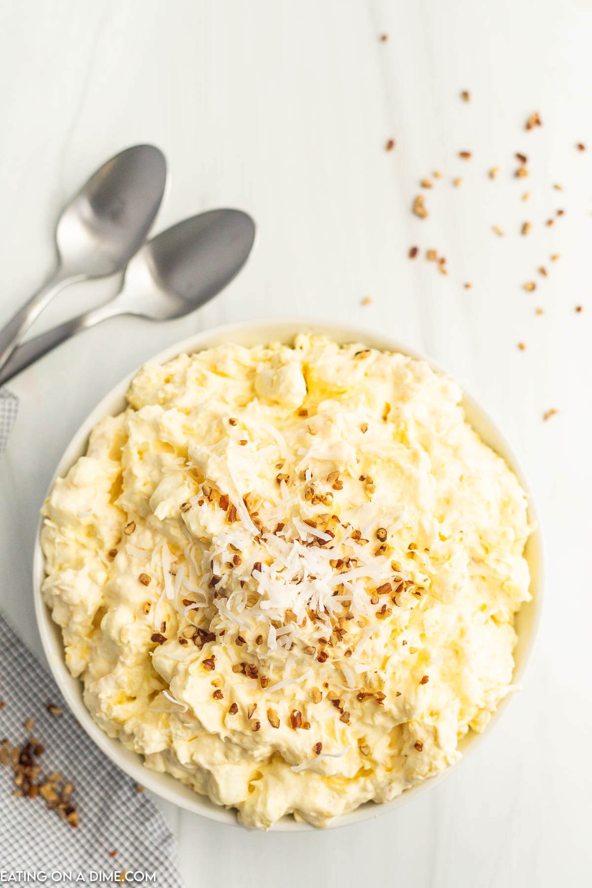 Pineapple Fluff Salad topped with chopped nuts in a bowl