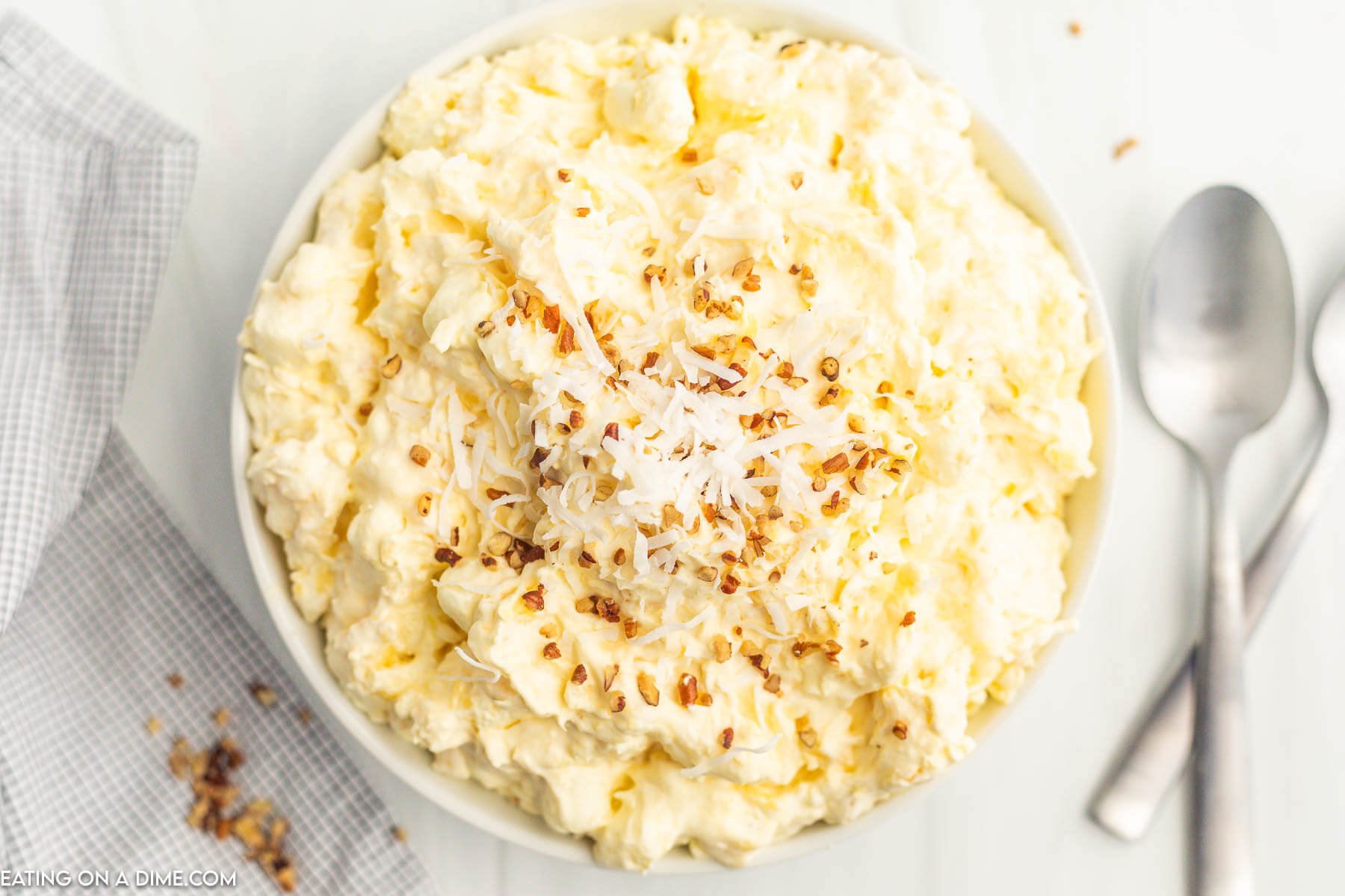 Pineapple Fluff Salad topped with chopped nuts in a bowl