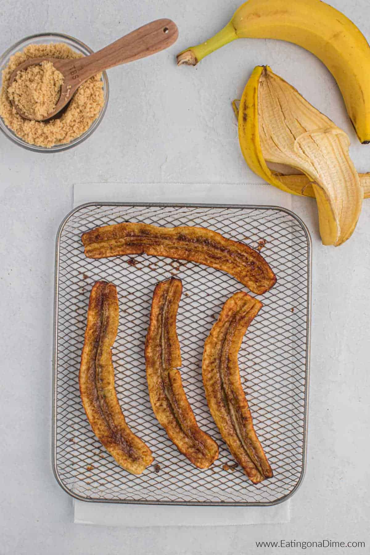 Bananas that have been air fried on a air fryer basket.