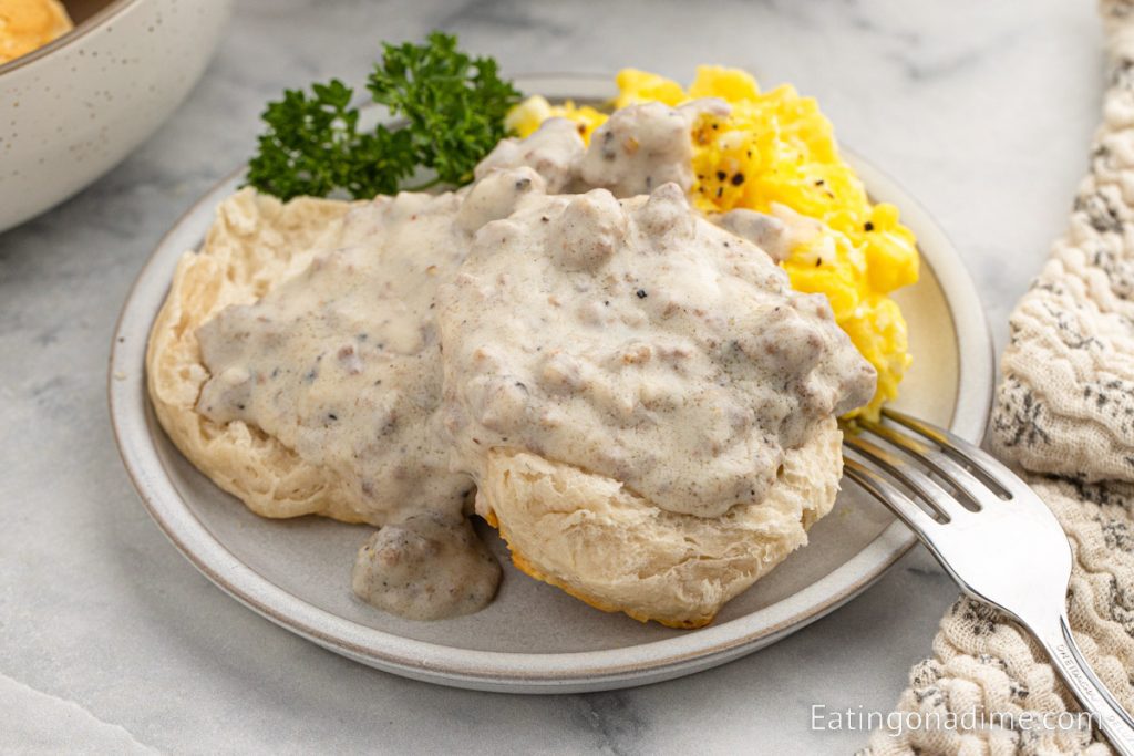 Sausage and Biscuit gravy on a plate with scrambled eggs