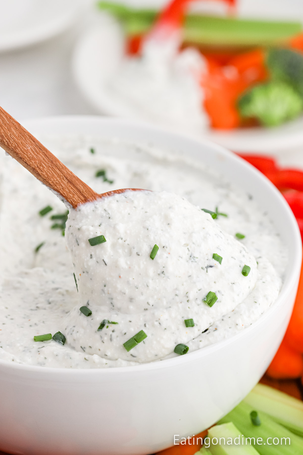 Close up image of cottage cheese dip with a wooden spoon