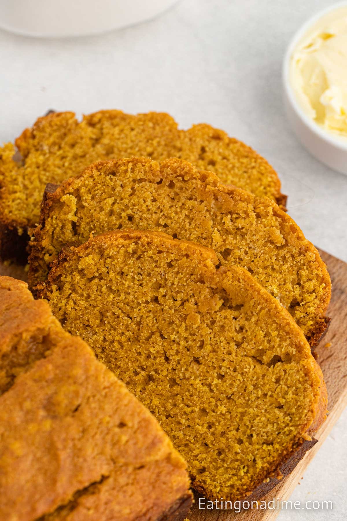 Slice pumpkin bread on a cutting board