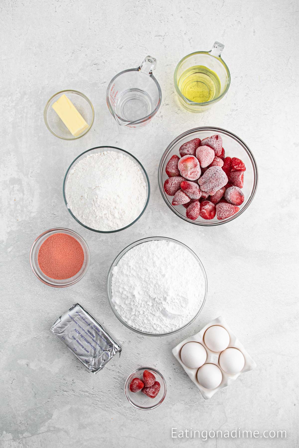 Ingredients needed for Strawberry Cake white cake mix, strawberry jello, frozen strawberries, eggs, oil, butter, cream cheese, powdered sugar, fresh strawberries
