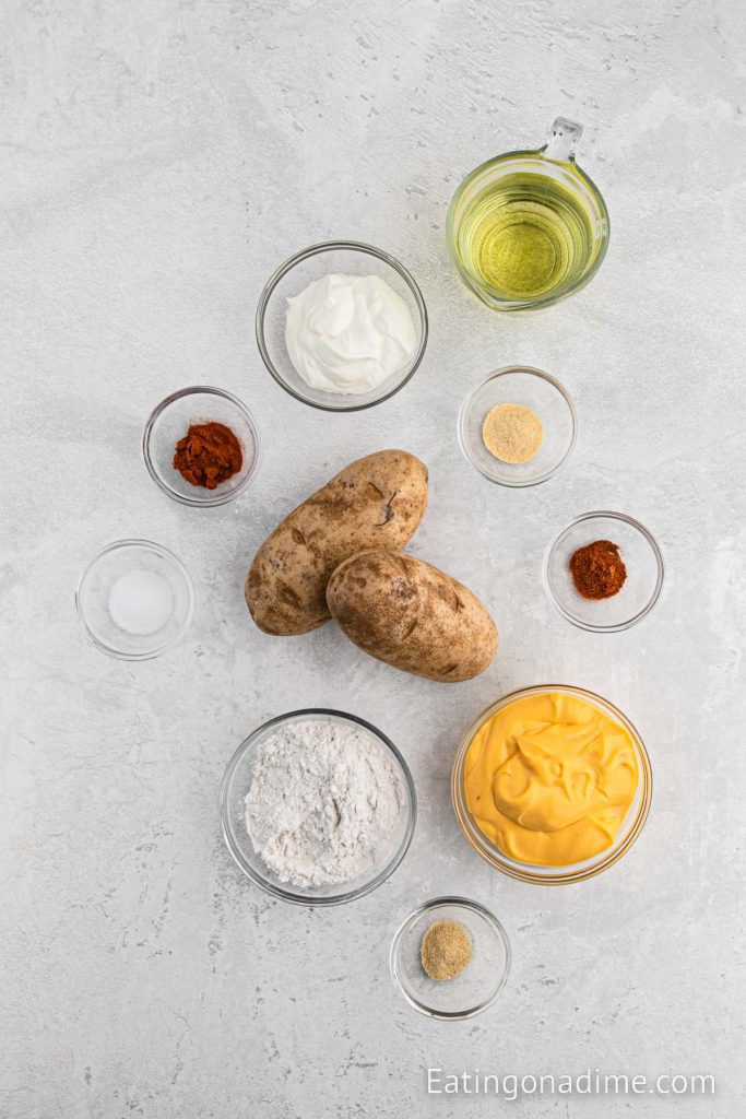 Ingredients needed - potatoes, oil, flour, onion powder, garlic powder, paprika, cayenne pepper, salt, nacho cheese, sour cream