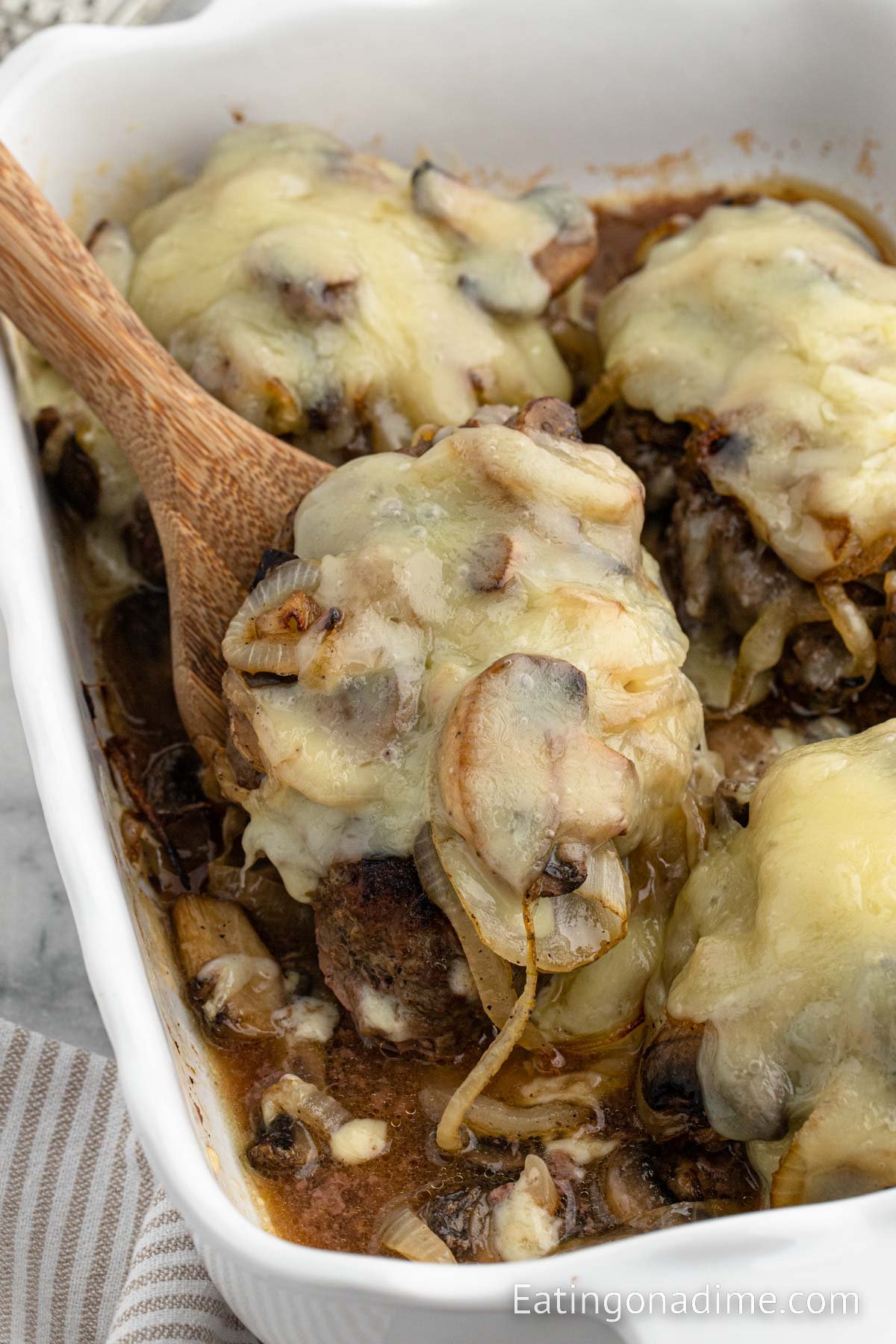 Roadkill in a baking dish with a wooden spoon