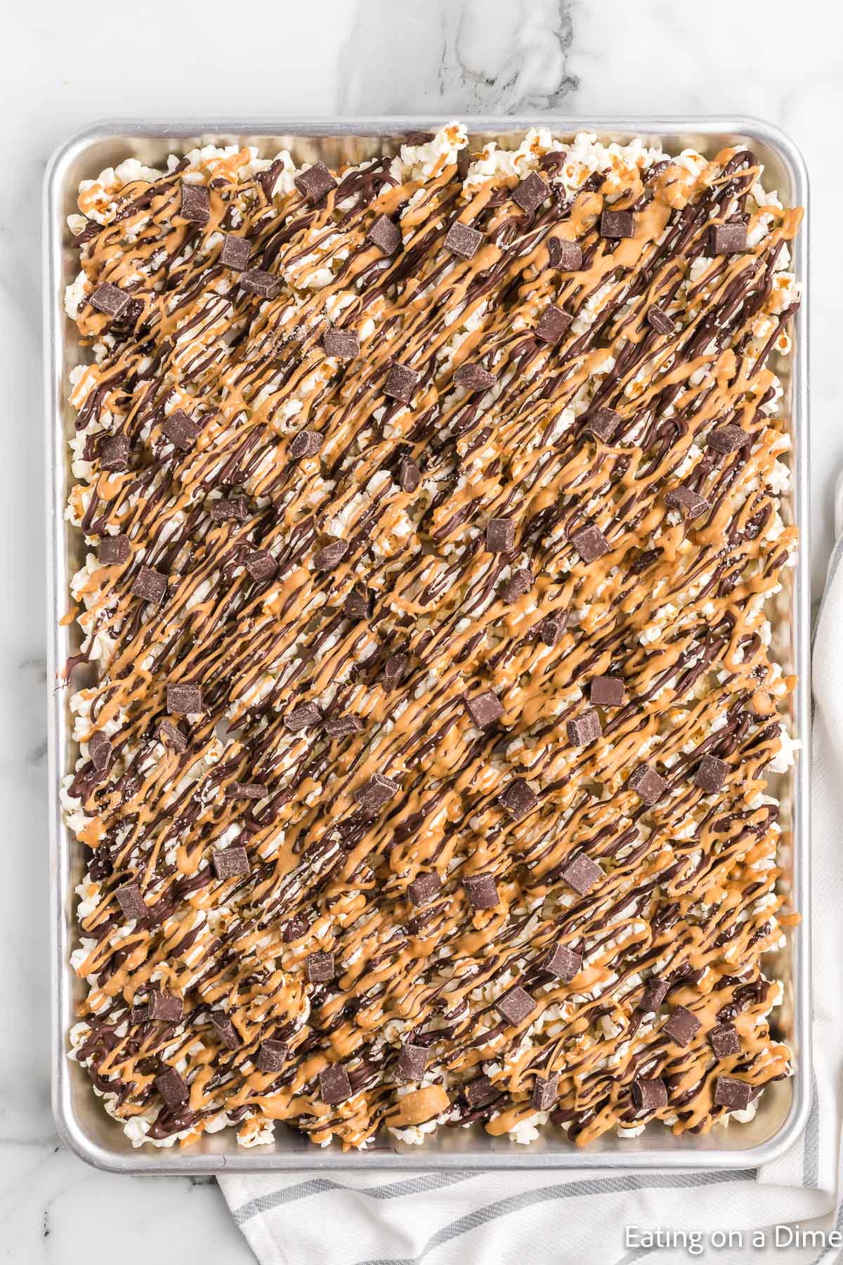 Chocolate Peanut Butter Popcorn on a baking sheet
