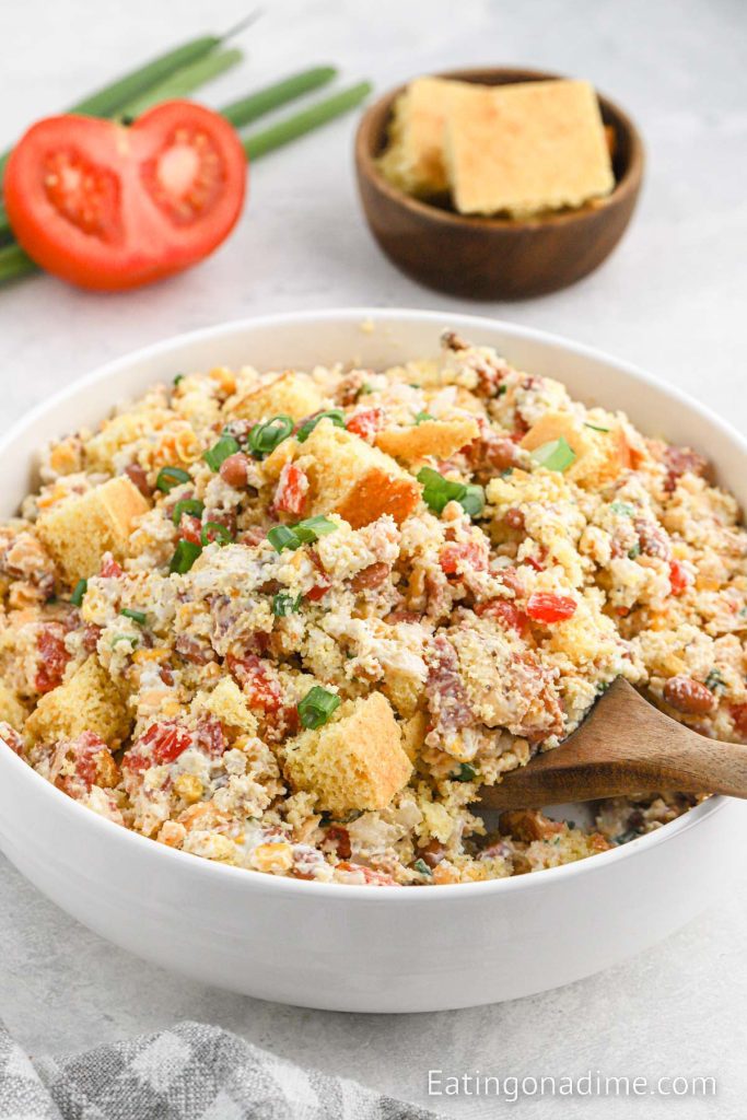 Bowl of Cornbread Salad with a wooden spoon