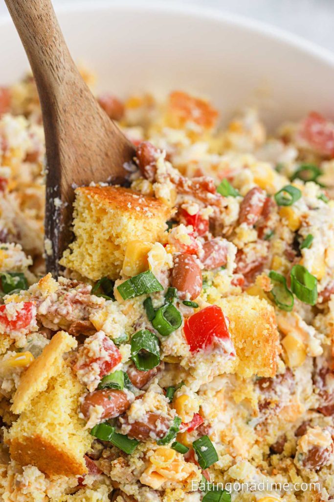 Bowl of Cornbread Salad with a wooden spoon