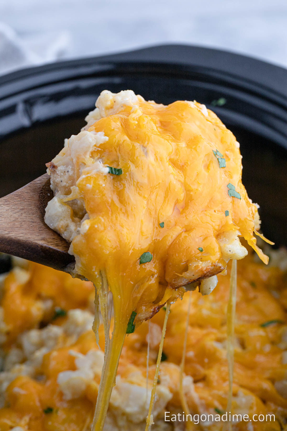 Funeral potatoes on a wood spoon