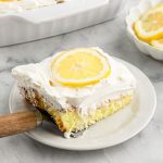 A piece of cake on a plate with a fork.