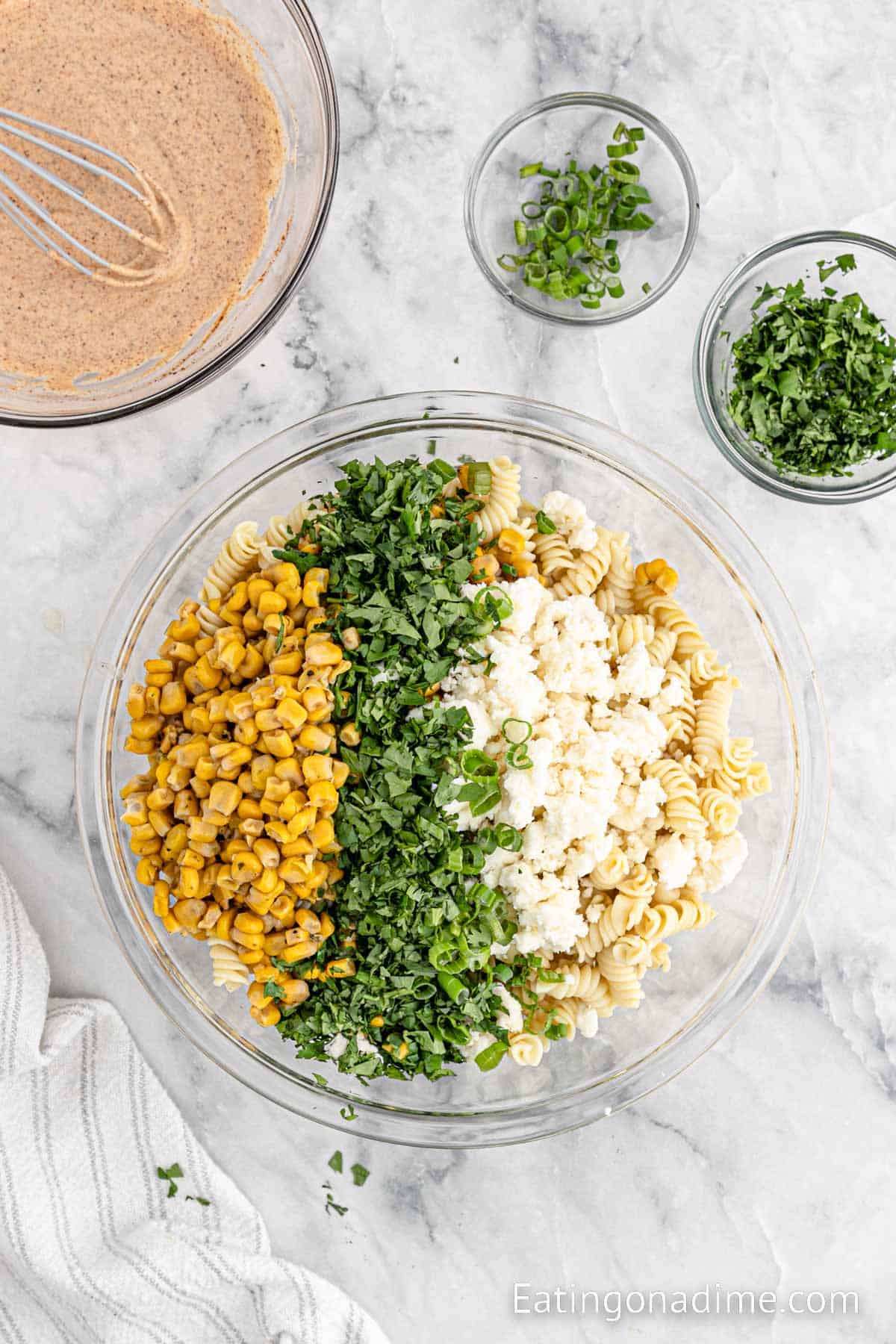 Layering the ingredients over the pasta in a bowl