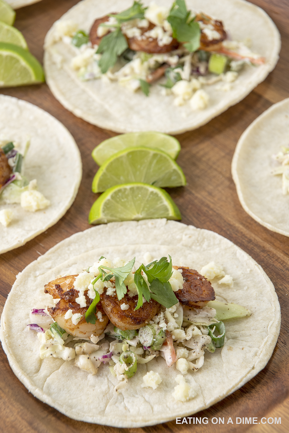Shrimp tacos with lime wedges