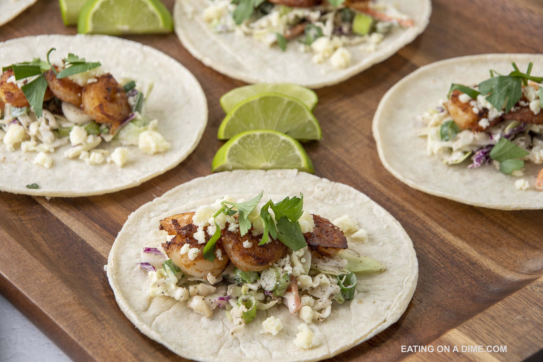 Shrimp tacos with lime wedges