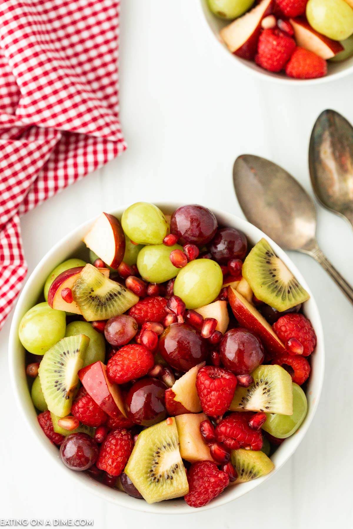 Bowl of fresh fruit with grapes, kiwi, raspberries and apples