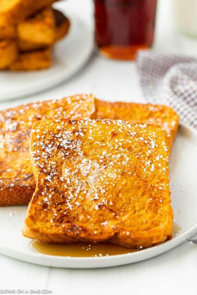 French Toast stacked on a plate with powdered sugar