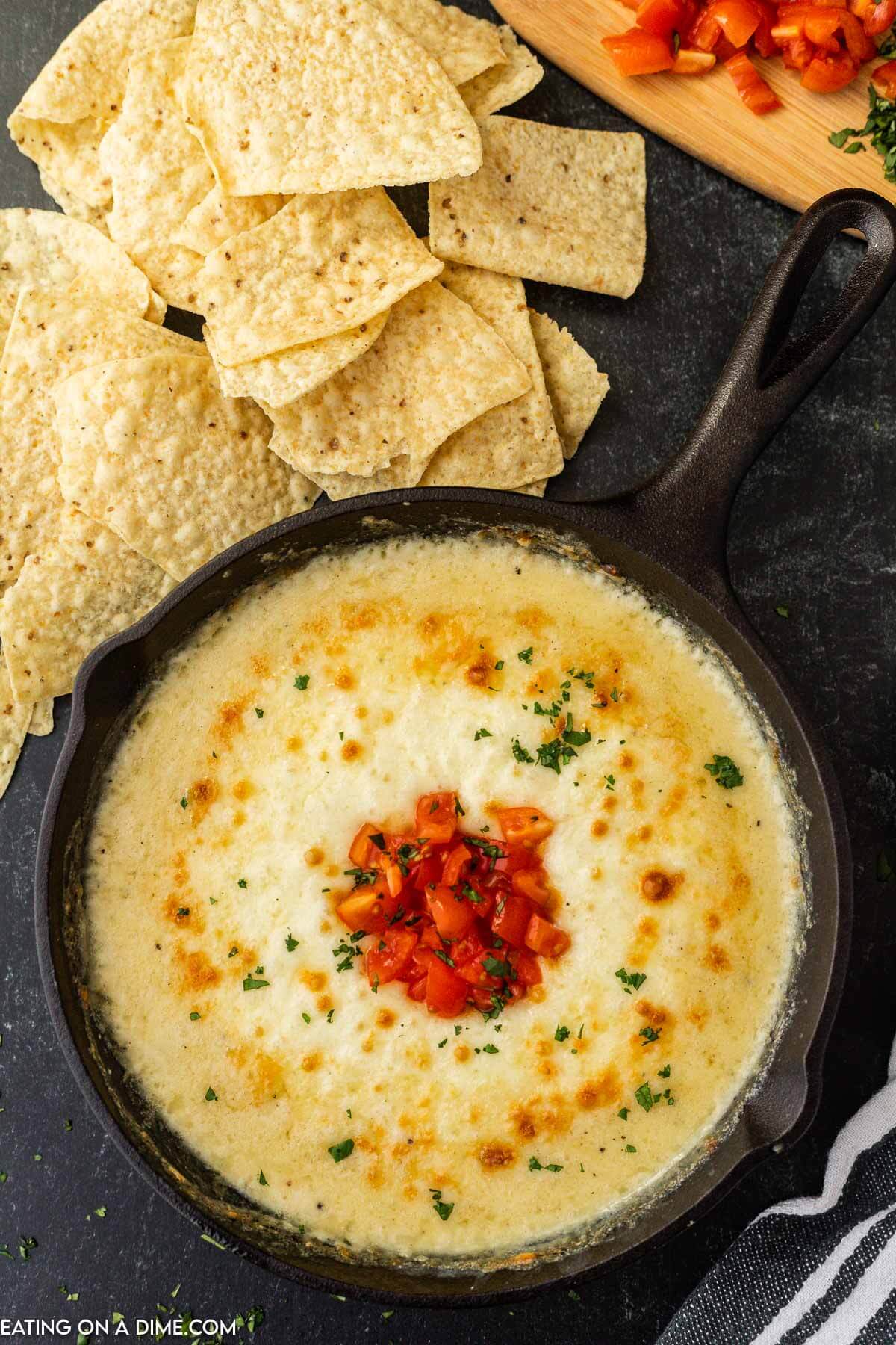 Queso Fundido in a skillet with a side of tortilla chips