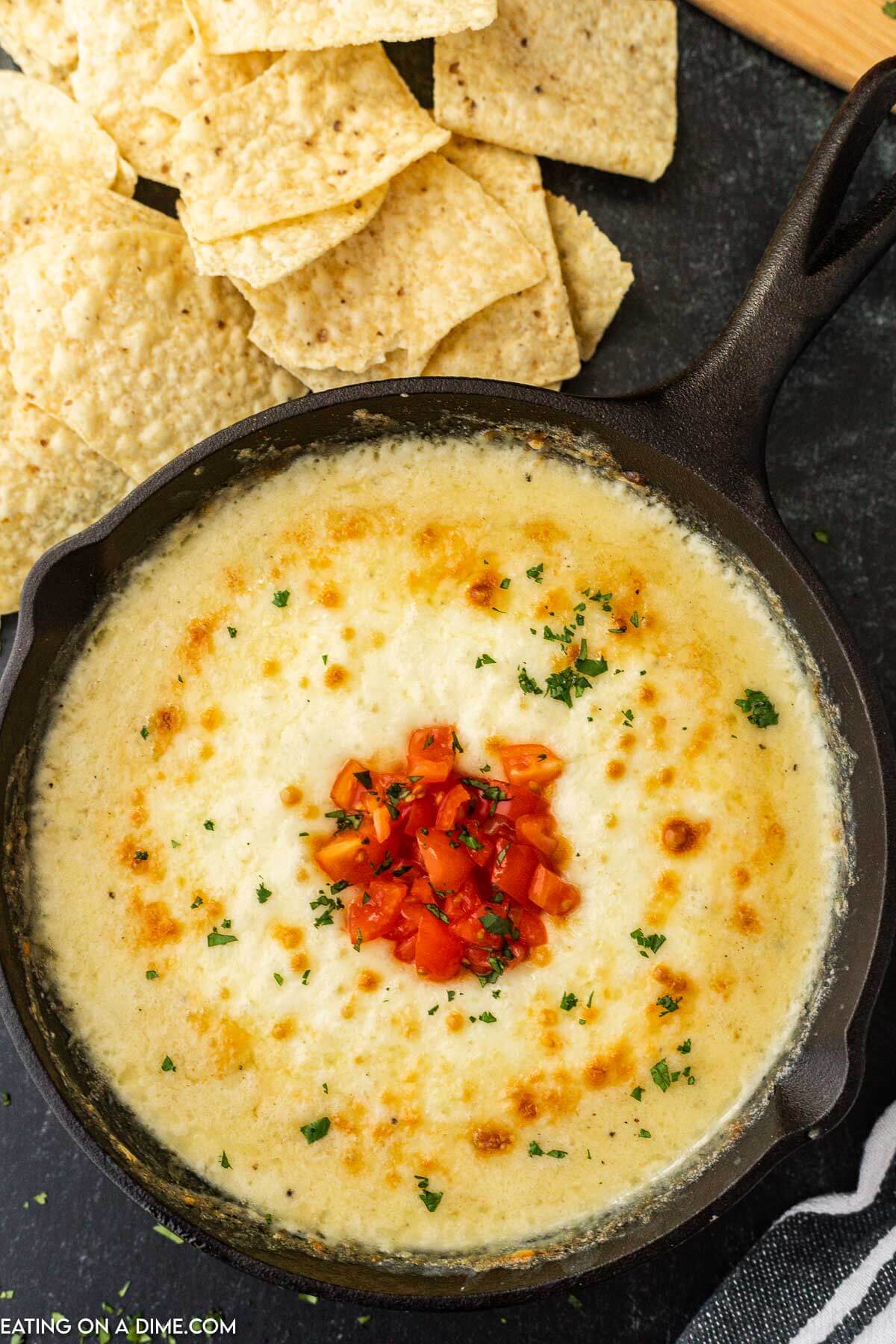 Queso Fundido in a skillet with a side of tortilla chips