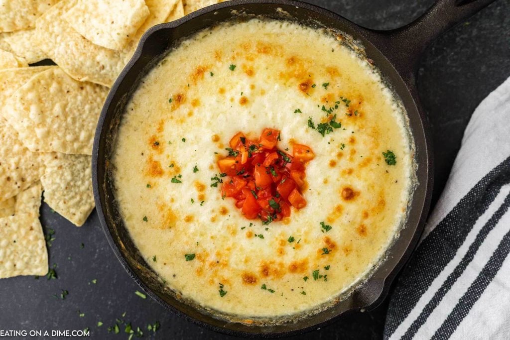Queso Fundido in a skillet with a side of tortilla chips