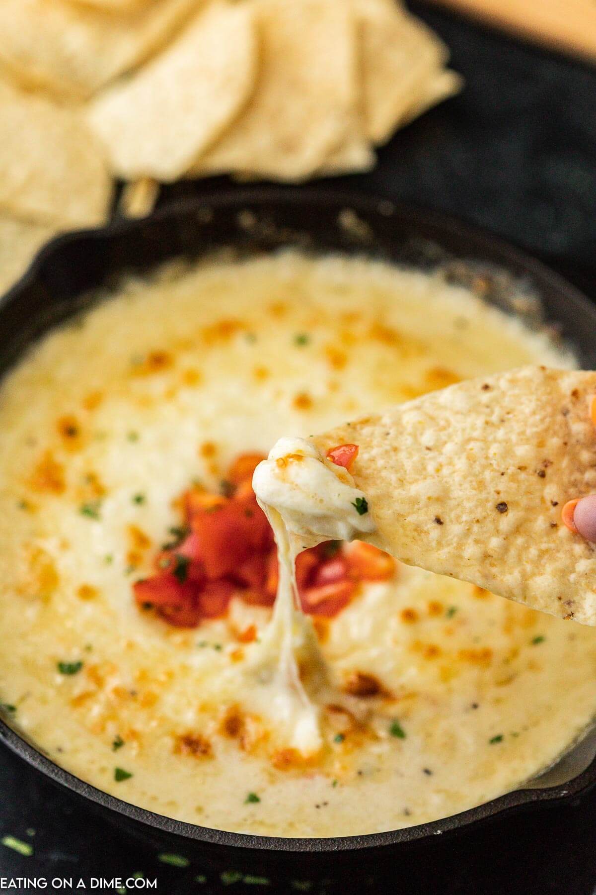 Queso Fundido in a skillet with a side of tortilla chips