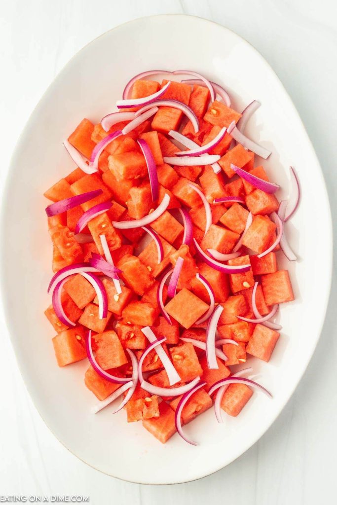 watermelon and red onions on a platter