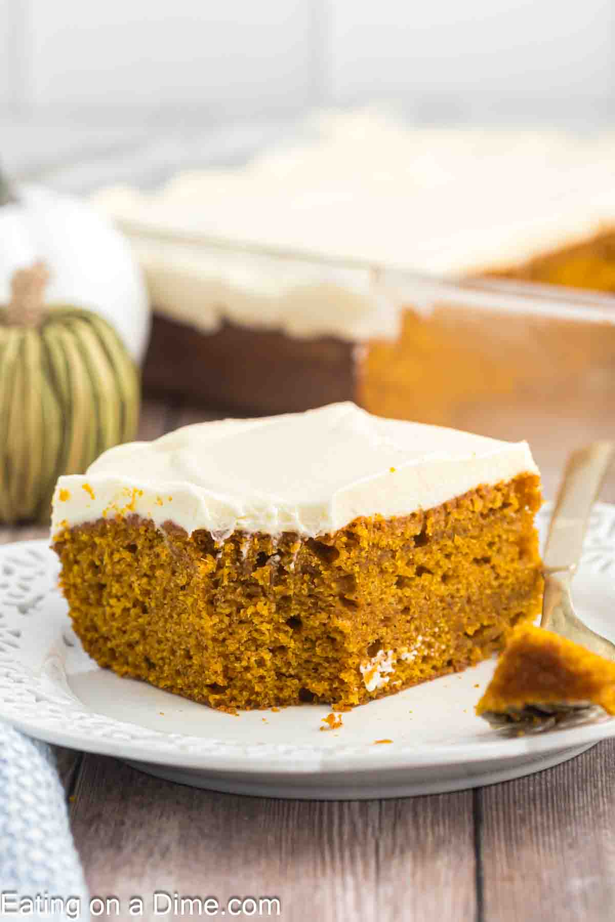 Slice of pumpkin cake with cream cheese frosting