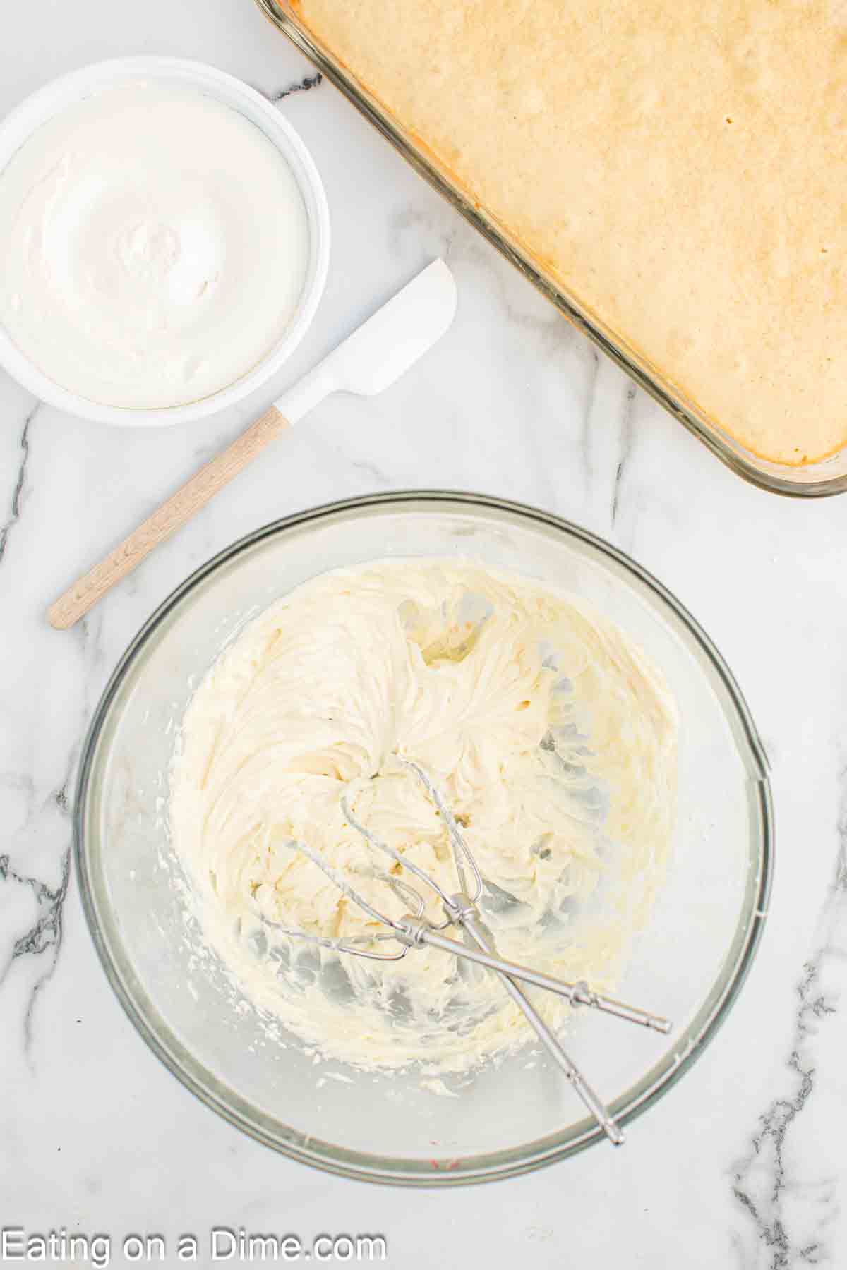 Beating cream cheese, powdered sugar, and vanilla in a bowl