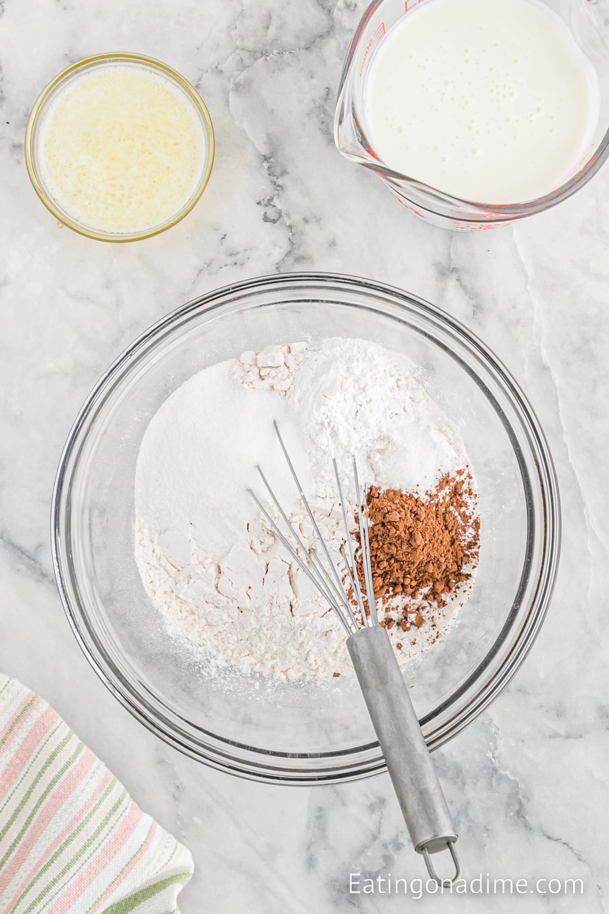Dry ingredients in a bowl with a whisk.