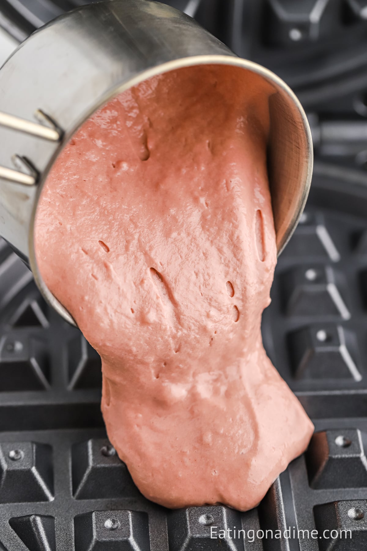 Batter spread on waffle iron.