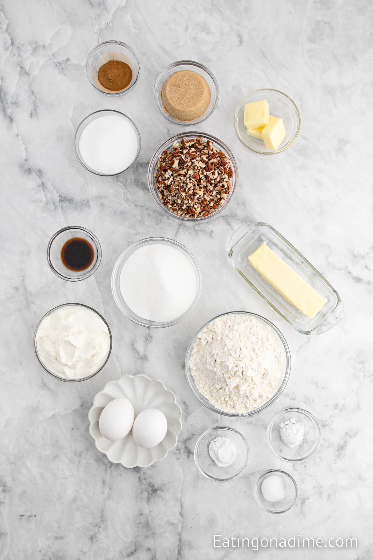 Ingredients for coffee cake- Flour, baking powder, baking soda, salt, sugar, butter, eggs, sour cream, vanilla extract, pecans, brown sugar, cinnamon