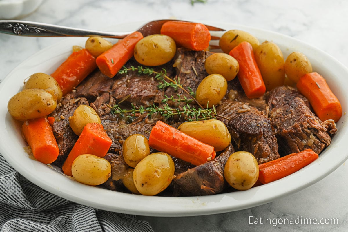 Pot roast, carrots, and potatoes on a platter