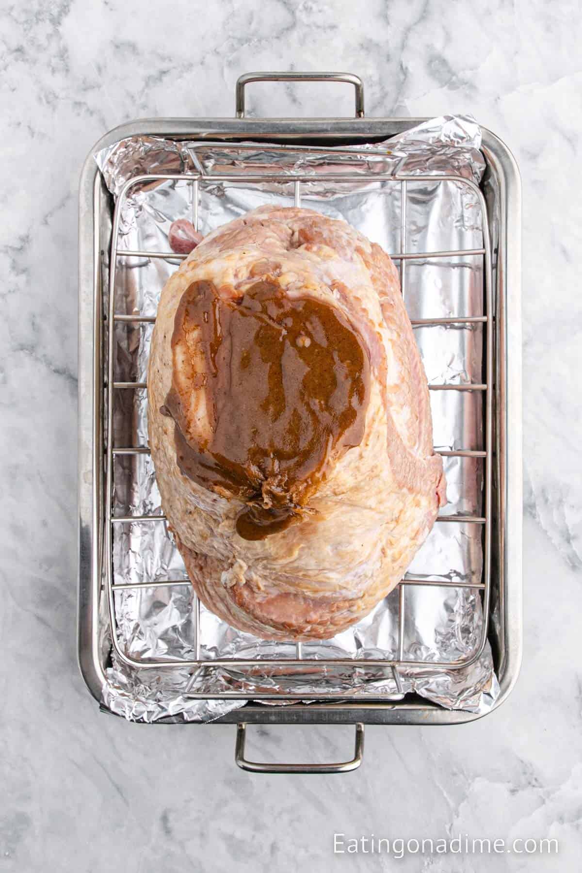 Ham on a roasting pan with glaze on the top