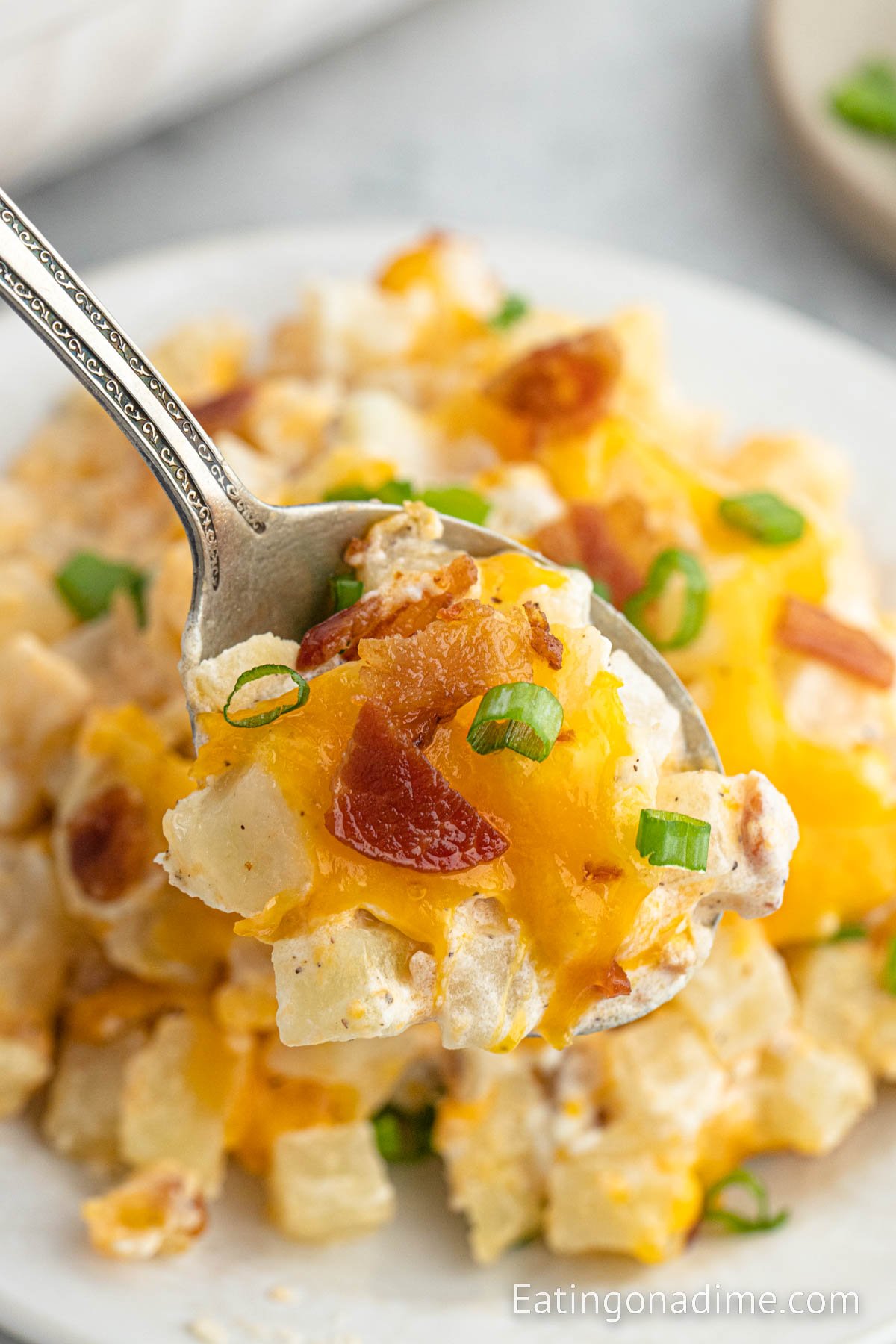 Baked Potato Casserole on a plate with a bite on a spoon