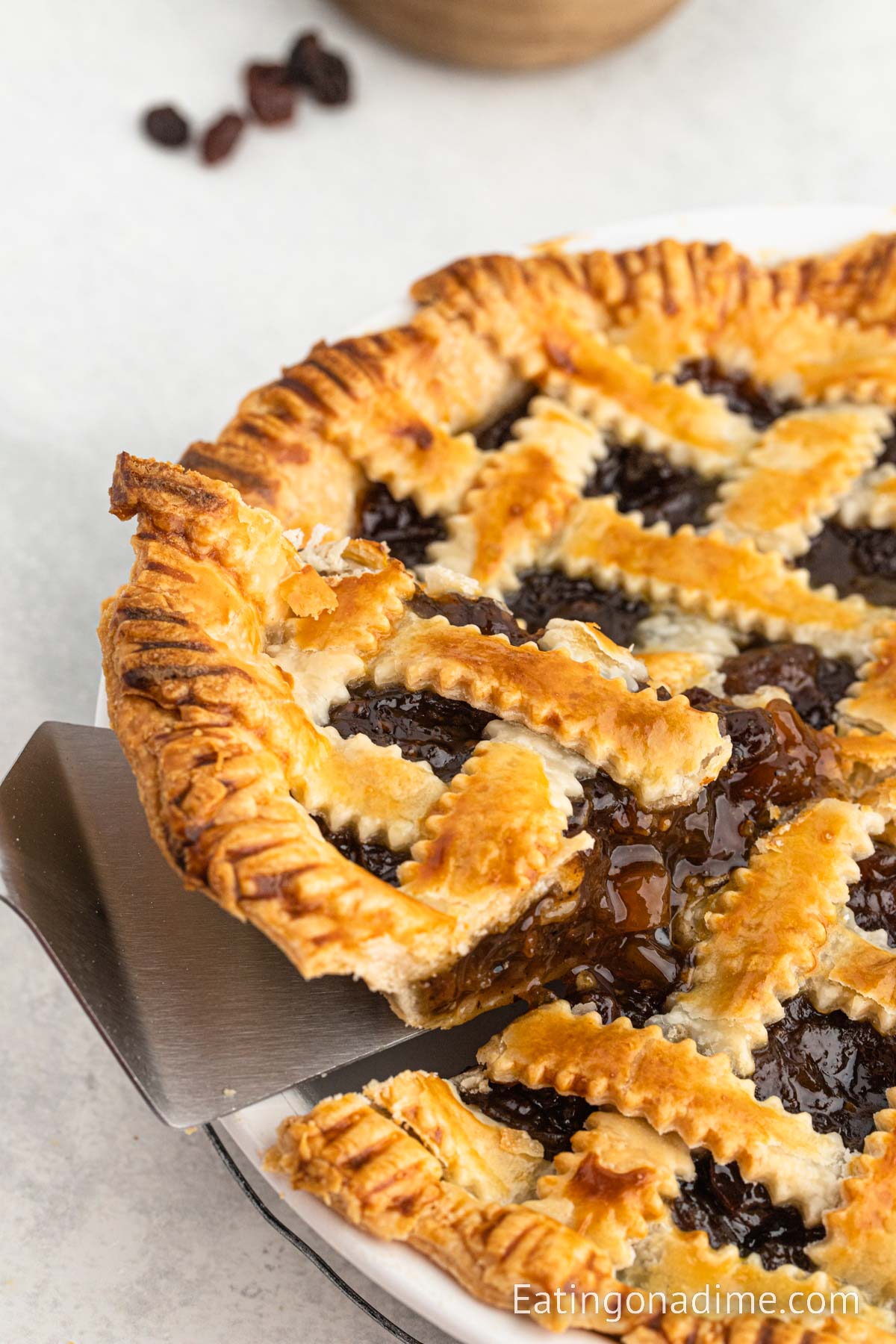 Mincemeat pie with a serving on a spatula