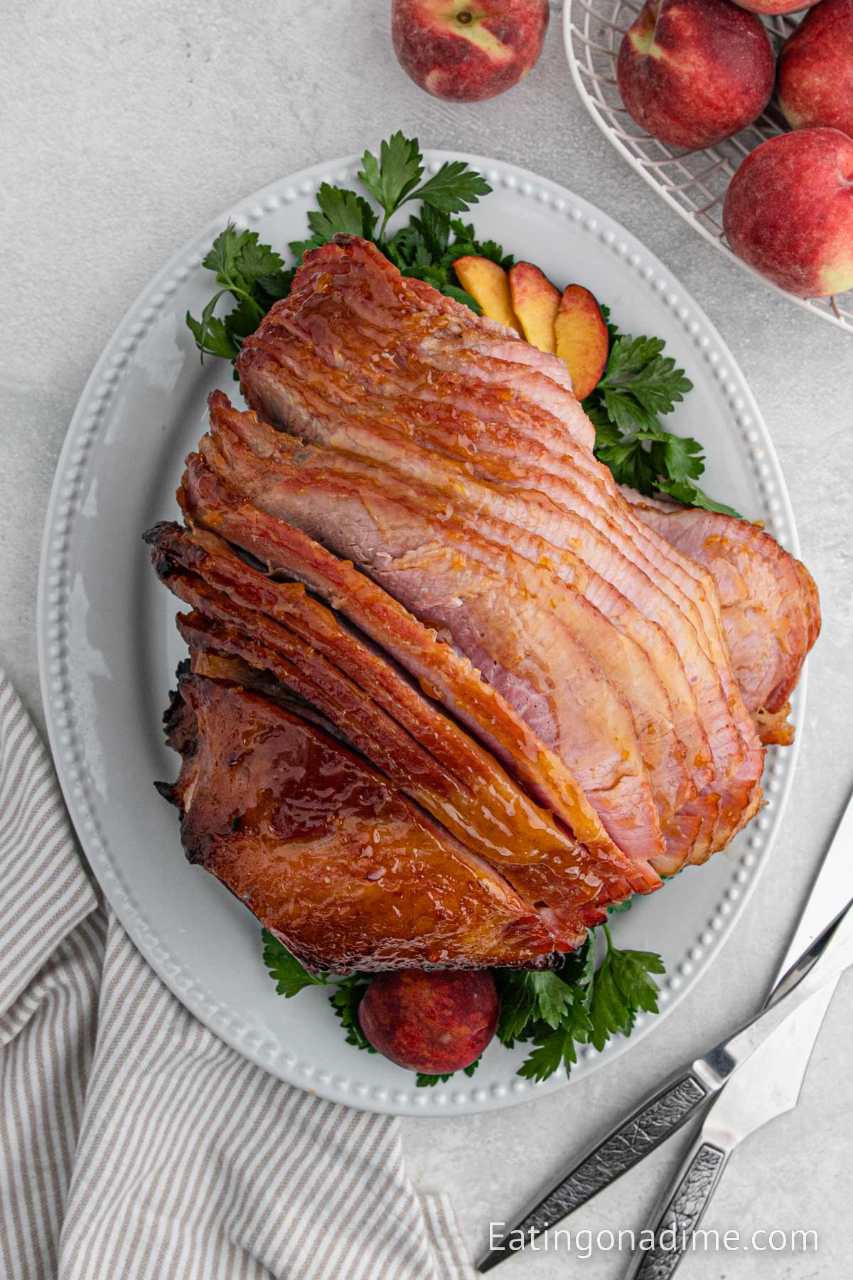 Slice peach glazed ham on a plate