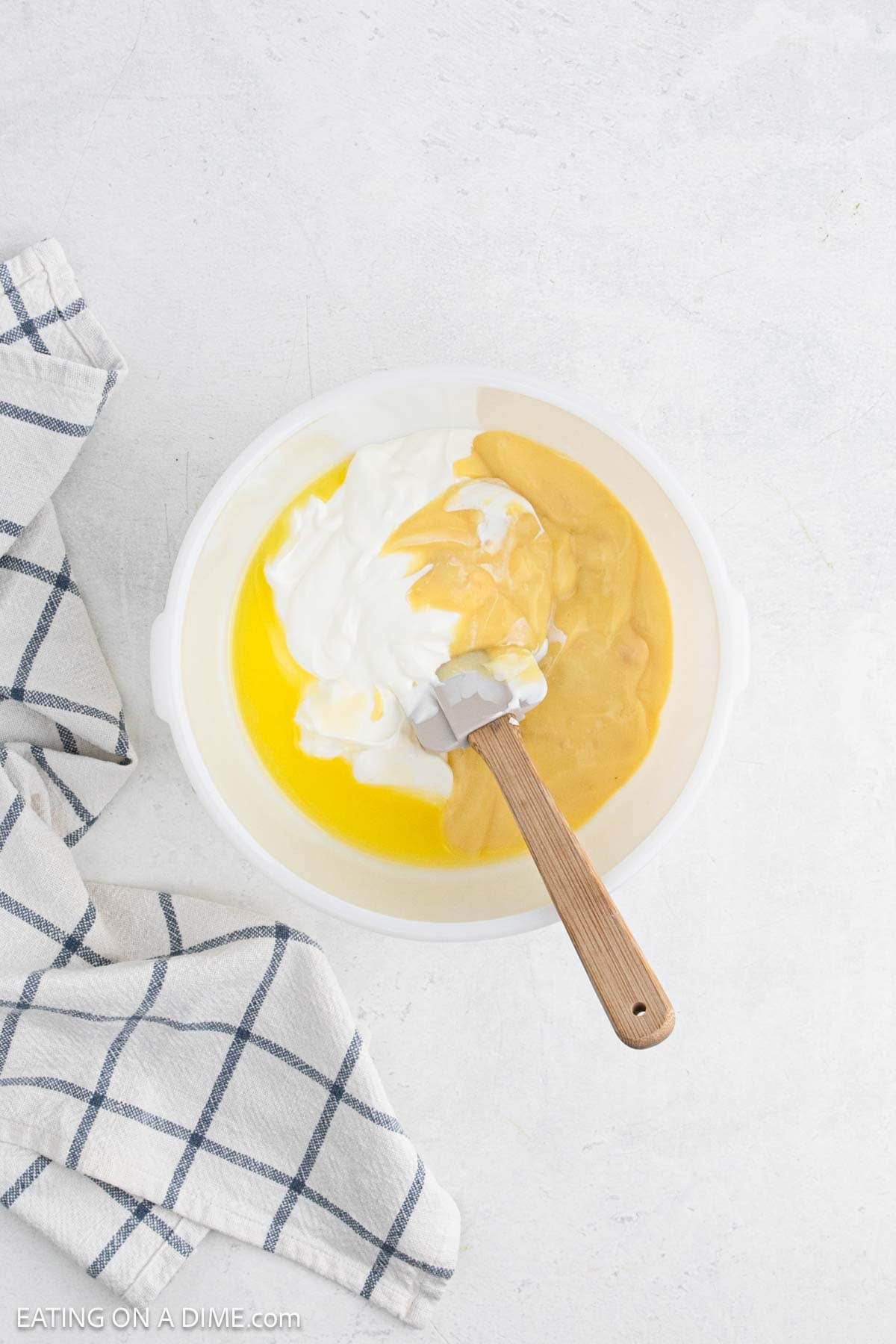 Combined cream of chicken soup and sour cream in a bowl.