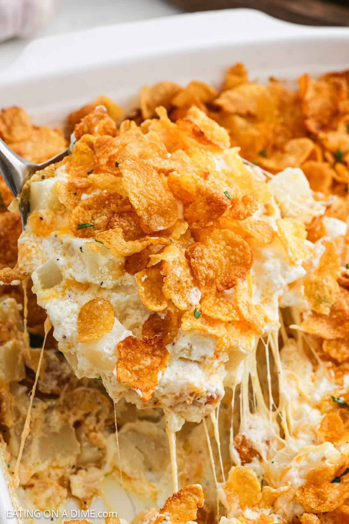 Golden brown, crispy hashbrown mixture on a spoon ready to serve.