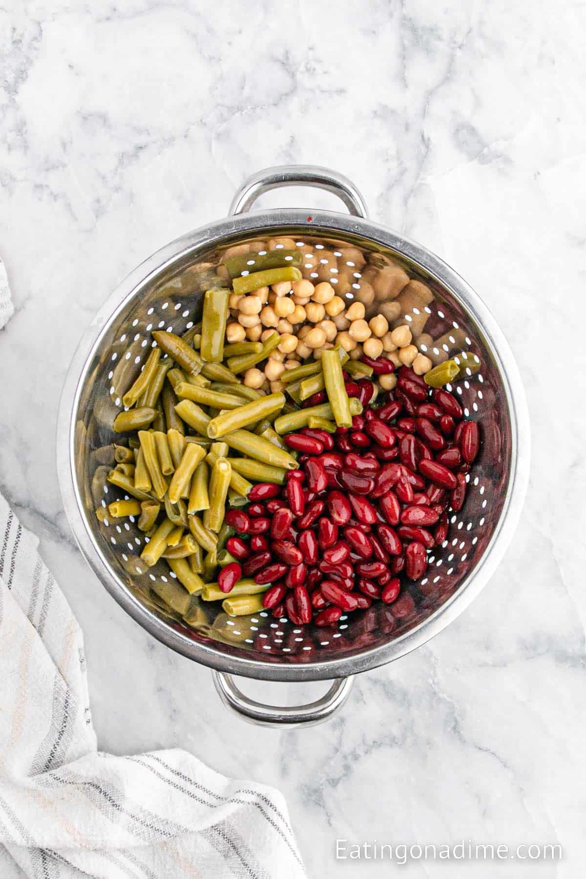 Placing beans in colander to rinse and drain