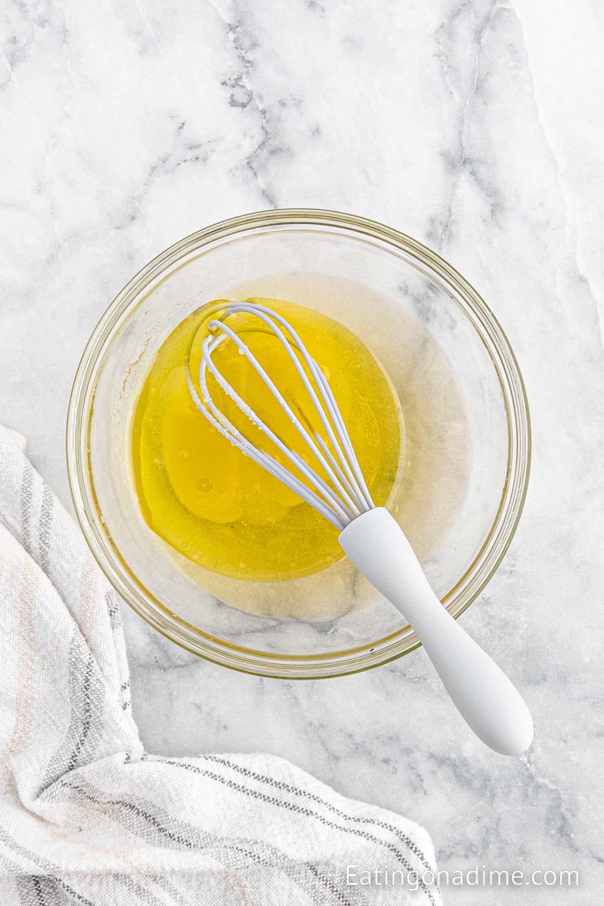 whisking together dressing in a bowl