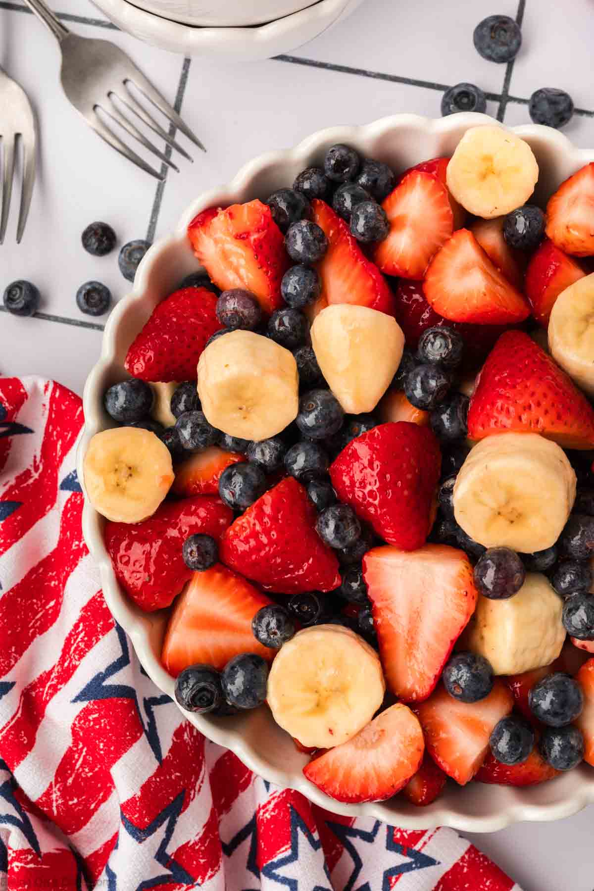 Blueberries, strawberries, bananas in a white bowl