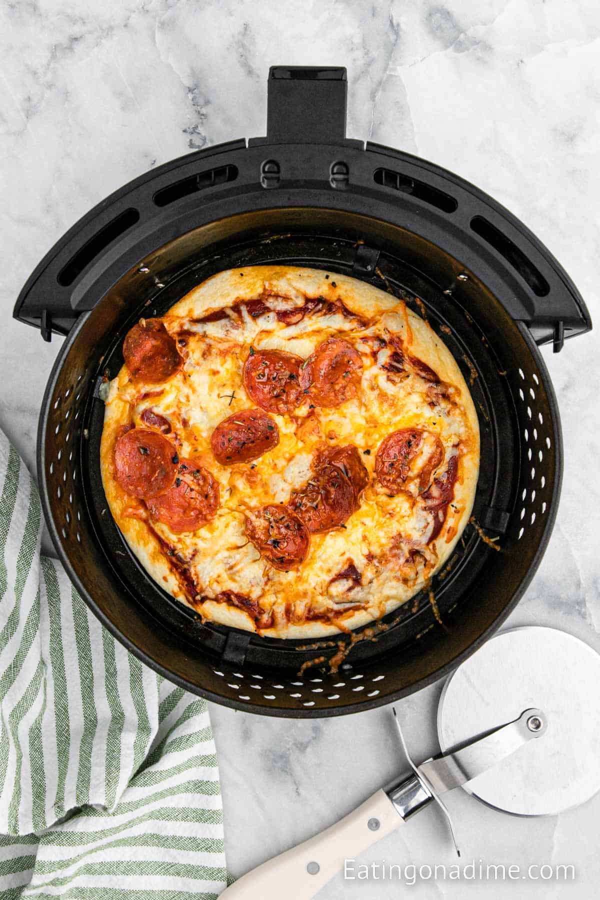 Cooked Air Fryer Pizza in the air fryer basket