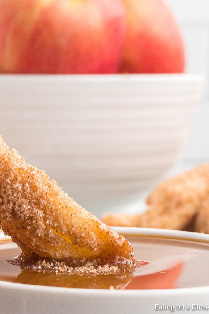 Dipping apple fries in caramel sauce